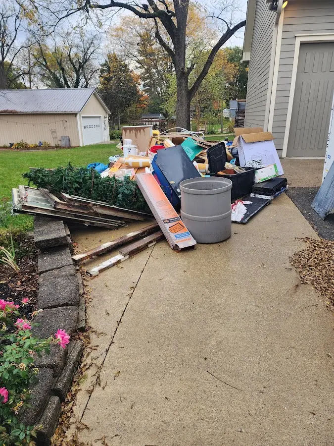 Dumpster being loaded with debris for 3 Yard Dumpster Rental in Altus